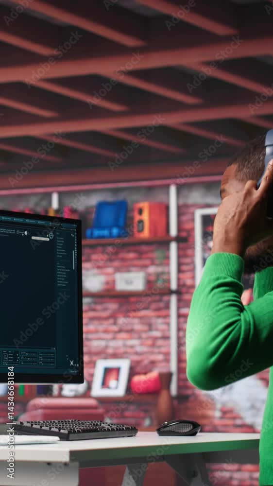 Fototapete Vertical Video African American worker using generative AI program with photos in a modern loft. Young man creating visual content with deep learning models and prompts on monitor with AI interface