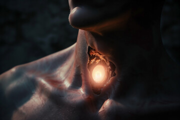 Fototapeta premium A close-up on a humanoid neck showcasing a glowing implant, revealing anatomical detail with light and shadow in a dark environment.