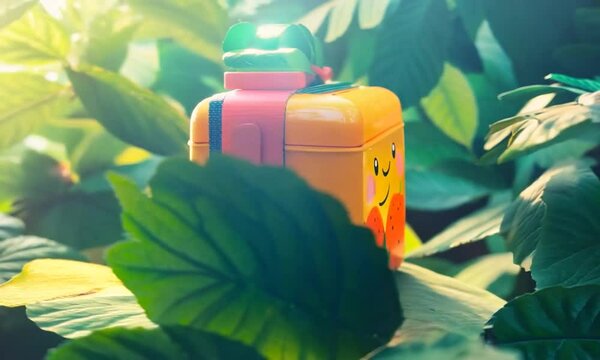 A vibrant, colorful backpack resting among lush green foliage, capturing a serene outdoor moment