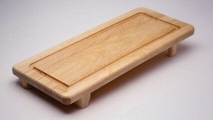 Fototapeta premium A light wooden serving board with a recessed center, perfect for presenting culinary creations.