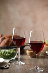Red wine and delicious dinner served on wooden table