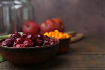Tasty cherries and other fruits on wooden table, closeup. Space for text
