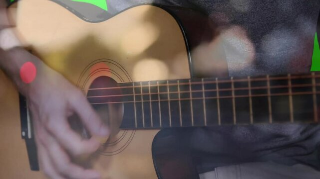 Acoustic guitar performing warm wooden tone in flat design with six steel strings under yellow pick