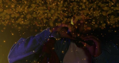 Male musician performing harmonica on stage, showcasing animated golden bokeh for music marketing - Powered by Adobe