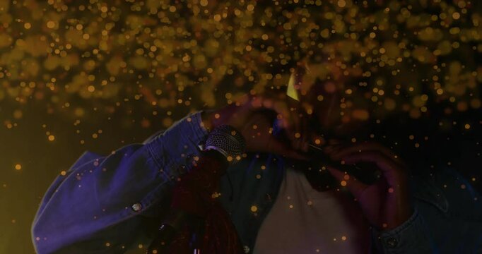 Male musician performing harmonica on stage, showcasing animated golden bokeh for music marketing