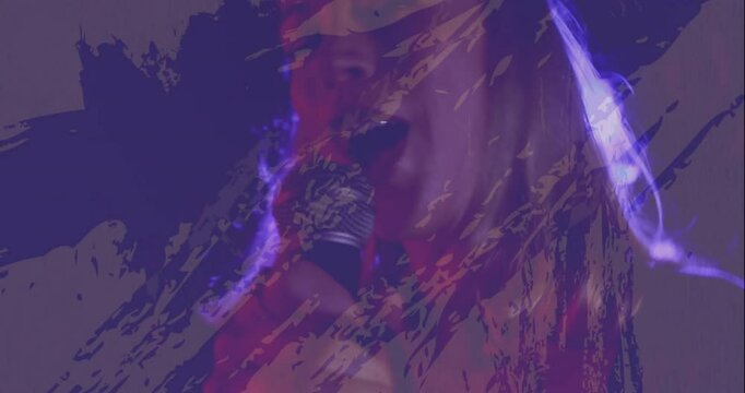 female singer singing into mic on stage, featuring music industry graphics with purple textures
