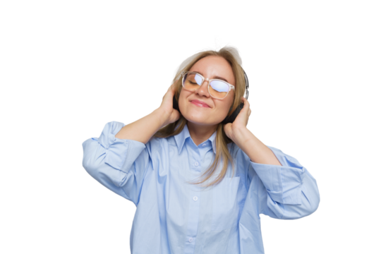 Joyful woman enjoying music while wearing headphones in a bright studio, embracing the rhythm of her favorite tunes