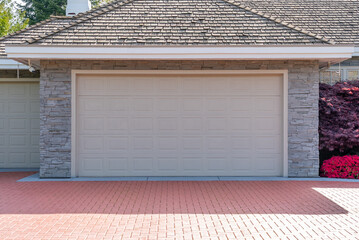 Garage door in luxury house with trees and nice landscape in Spring in Vancouver, Canada, North...