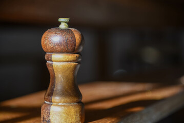 wooden salt shaker on kitchen table.