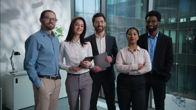 Happy Caucasian African American Indian businesswomen businessmen office corporate portrait pose looking at camera multiracial group colleagues diversity coworkers professional team business men women