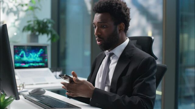 Stressed worried African American man using mobile phone smartphone computer fail problem negative businessman shocked frustrated male reading bad news guy business manager employer lose online office