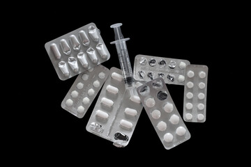 A close-up shot of different drugs and medicine on a black background