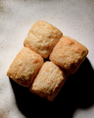 Four small, golden brown cookies are arranged in a square