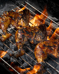 Three pieces of chicken are on a grill