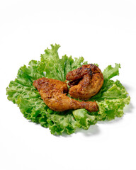 A plate of fried chicken on a bed of lettuce
