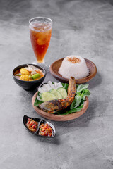 A plate of food with a bowl of soup and a glass of tea