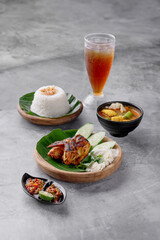 A plate of food with a bowl of soup and a glass of tea