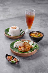 A plate of food with a bowl of soup and a glass of tea