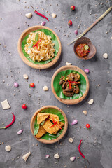Three bowls of food with a variety of ingredients, including meat, vegetables