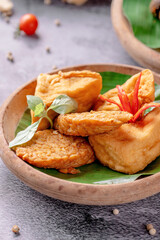 A plate of fried food with a leaf on top