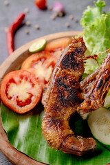 A plate of food with meat and vegetables on a green leaf