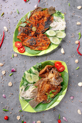 Two plates of food with fish and vegetables on a green plate