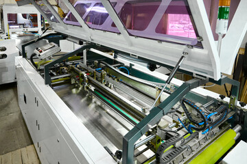 Innovative folding machine at work in a decorative box factory during a busy production shift