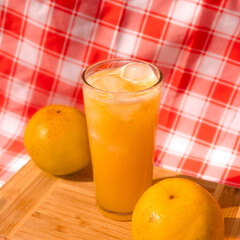glass of orange juice and oranges
