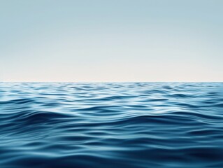 Fototapeta premium A serene seascape featuring calm, rippling waves under a clear blue sky, evoking tranquility and the beauty of nature.