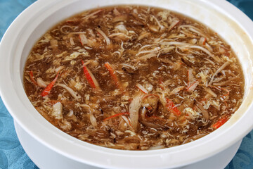 Mock shark fin soup delicacy in white bowl served at chinse banquet 