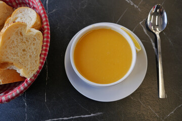 Warm soup served with fresh bread in a cozy setting