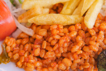 Delicious plate of spicy wheat and crispy fries in vibrant setting
