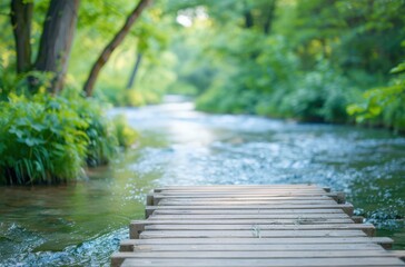 A serene wooden dock extends over a tranquil stream, surrounded by lush greenery and soft sunlight filtering through the trees.