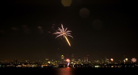 Fireworks Display Over City Skyline at Night with Sparkling Light Show