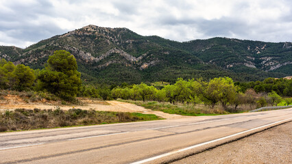 A road that runs between mountains in the landscape of the so-called Tuscany of Teruel in Matarrana.