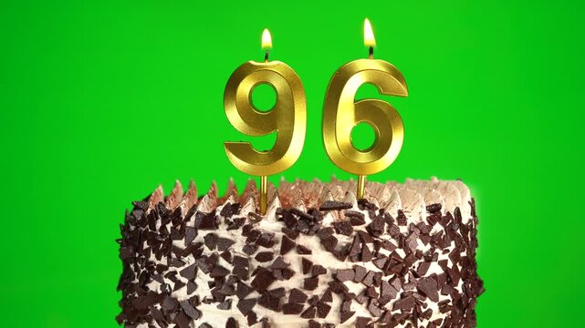 Burning candles number 96 on birthday cake against chroma key background. Ninety-sixth birthday. Birthday and anniversary celebration