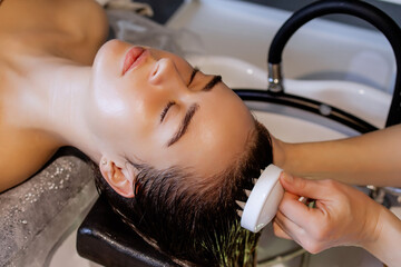 Japanese Head Spa Therapy: Relaxing Scalp Treatment at a Beauty Salon with massage brush, Focused on Scalp Care and Hair Wellness