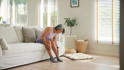 Asia adult people middle age old woman itch leg arm elbow body dry skin hand touch neck stress sad pain sit at home elder health care aging beauty illness issue. Asian female aged mosquito bite itchy.