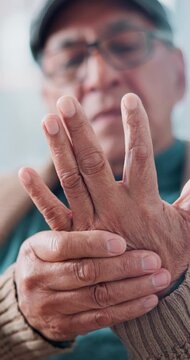 Senior man, massage and pain in hands with tension, arthritis complication and poor blood circulation in home. Elderly person, closeup and sore with joint inflammation, osteoporosis and carpal tunnel