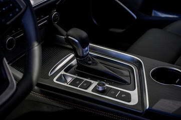 Automatic transmission selector in the interior of a modern car.