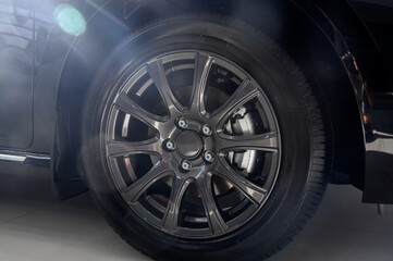Car wheel with brake calipers and stylish design.