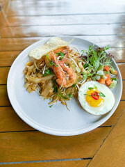 Elegant Presentation of Char Kuey Tiaw with Shrimp on a Rustic Dining Surface