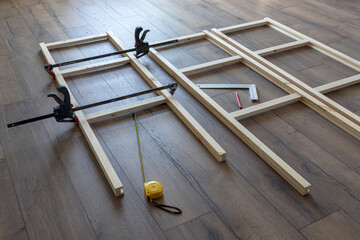process of making a wooden rack, parts clamped with clamps, carpentry