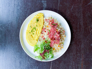 Generous Serving of Nasi Goreng Omlet with a Burst of Fresh Ingredients for a Colorful Meal