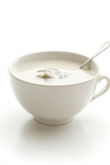 Creamy mushroom soup in a white bowl with a spoon on a clean white background captures simplicity and elegance with a minimalist style and a high angle view