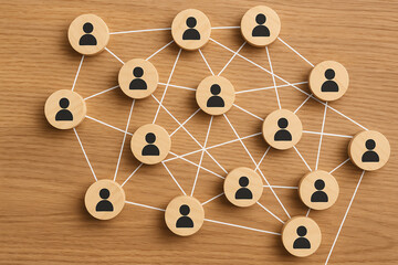 A creative representation of a social network with wooden tokens illustrating connections between individuals. Perfect for themes around teamwork, collaboration, and networking.
