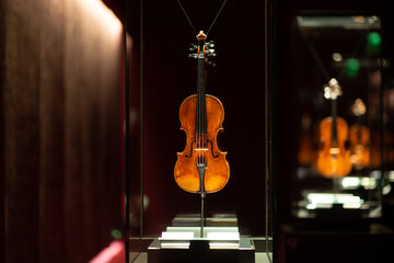 Violinmaking historical masterpieces on Display in Treasure box room in violin museum Cremona, Italy