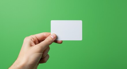 white hand holding blank credit card on green background