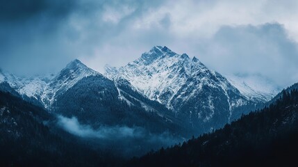 Majestic winter mountain landscape with snow covered peaks and dark forest sky ice fog cold view blue