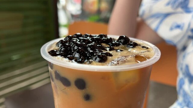 add topioca to coffee Woman drink of Iced milk bubble tea
